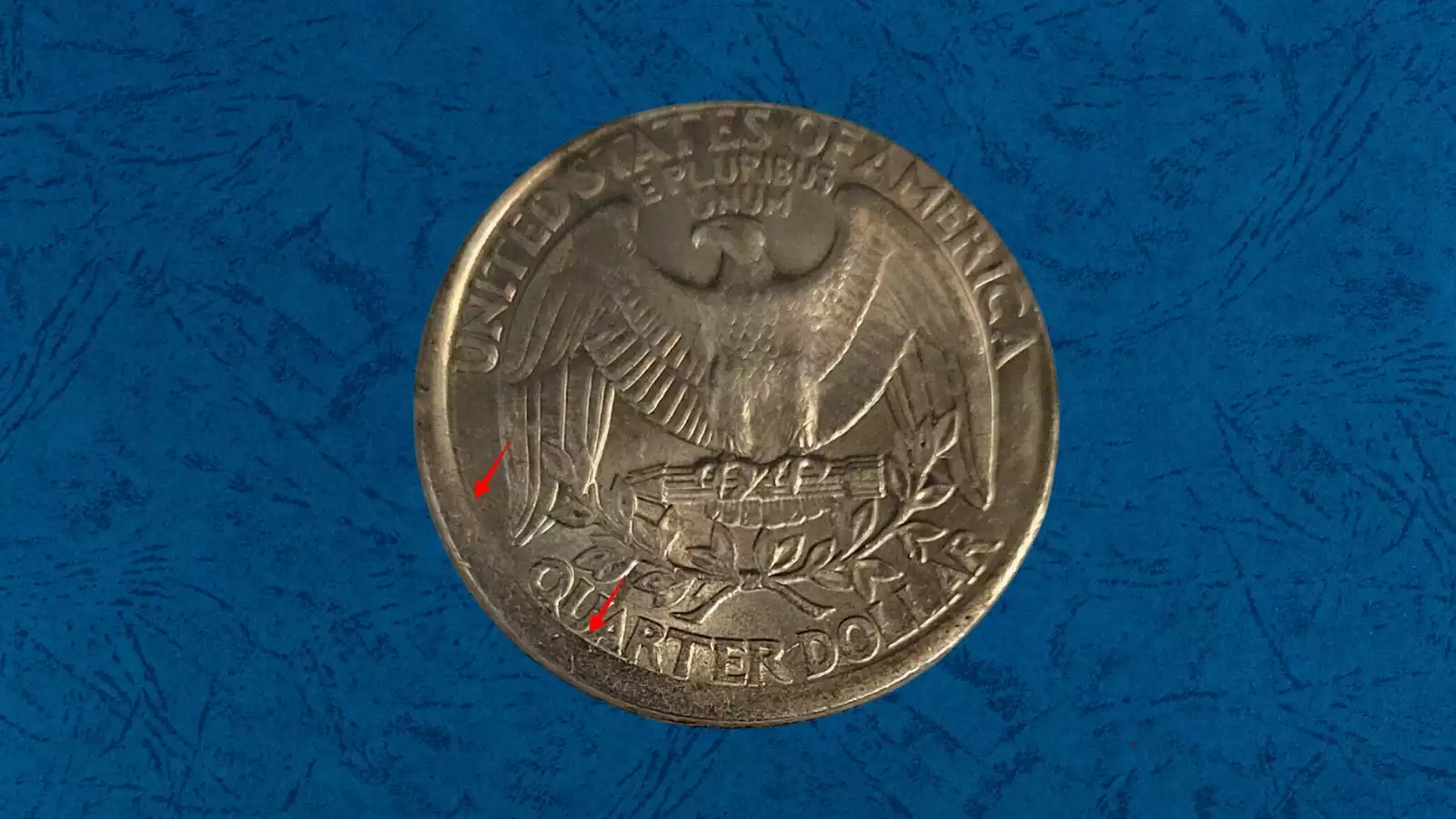 1986 quarter off-center strike error showing crescent-shaped blank area on one side