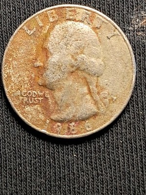 1986 quarter clipped planchet error showing curved section missing from coin edge